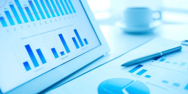 Image of workplace with paper and electronic documents and pen