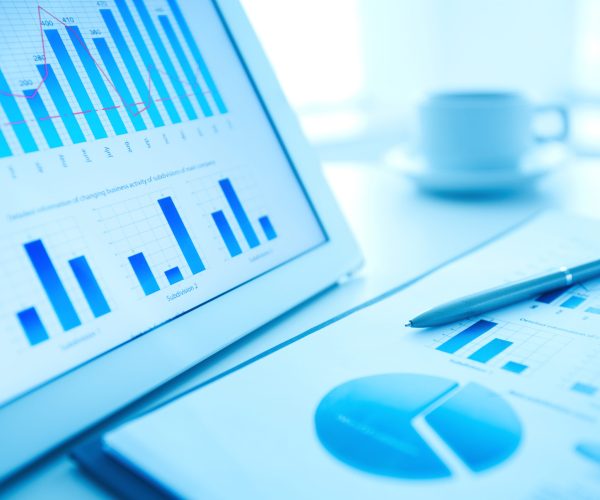 Image of workplace with paper and electronic documents and pen